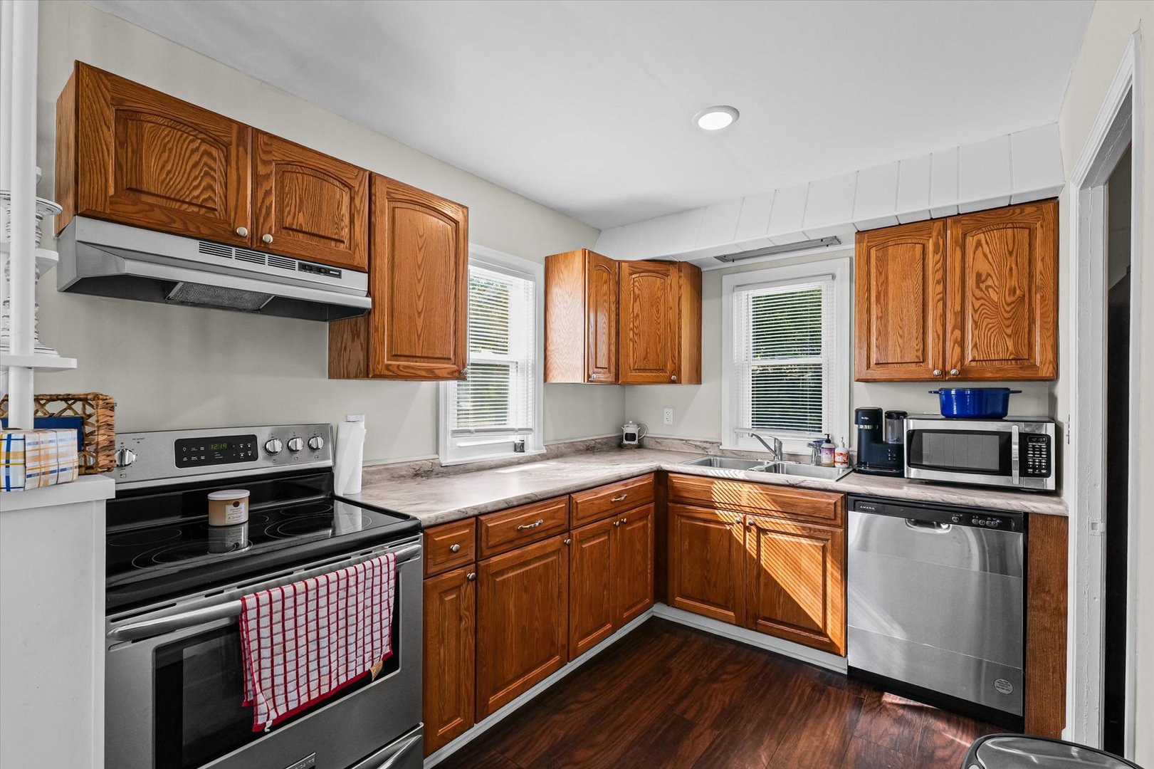 209 South Walnut Street Buckley, IL 60918 - Photo 12 of 30 a kitchen with stainless steel appliances granite countertop wooden cabinets stove top oven and sink