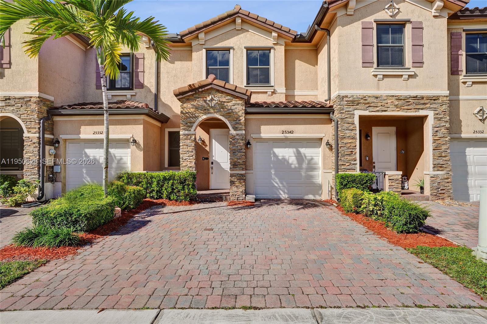 a front view of a house with yard and parking