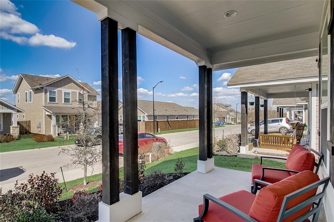 a view of a patio with couches chairs potted plants and a big yard