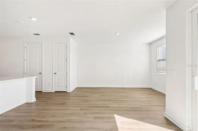 a kitchen with white cabinets and white appliances