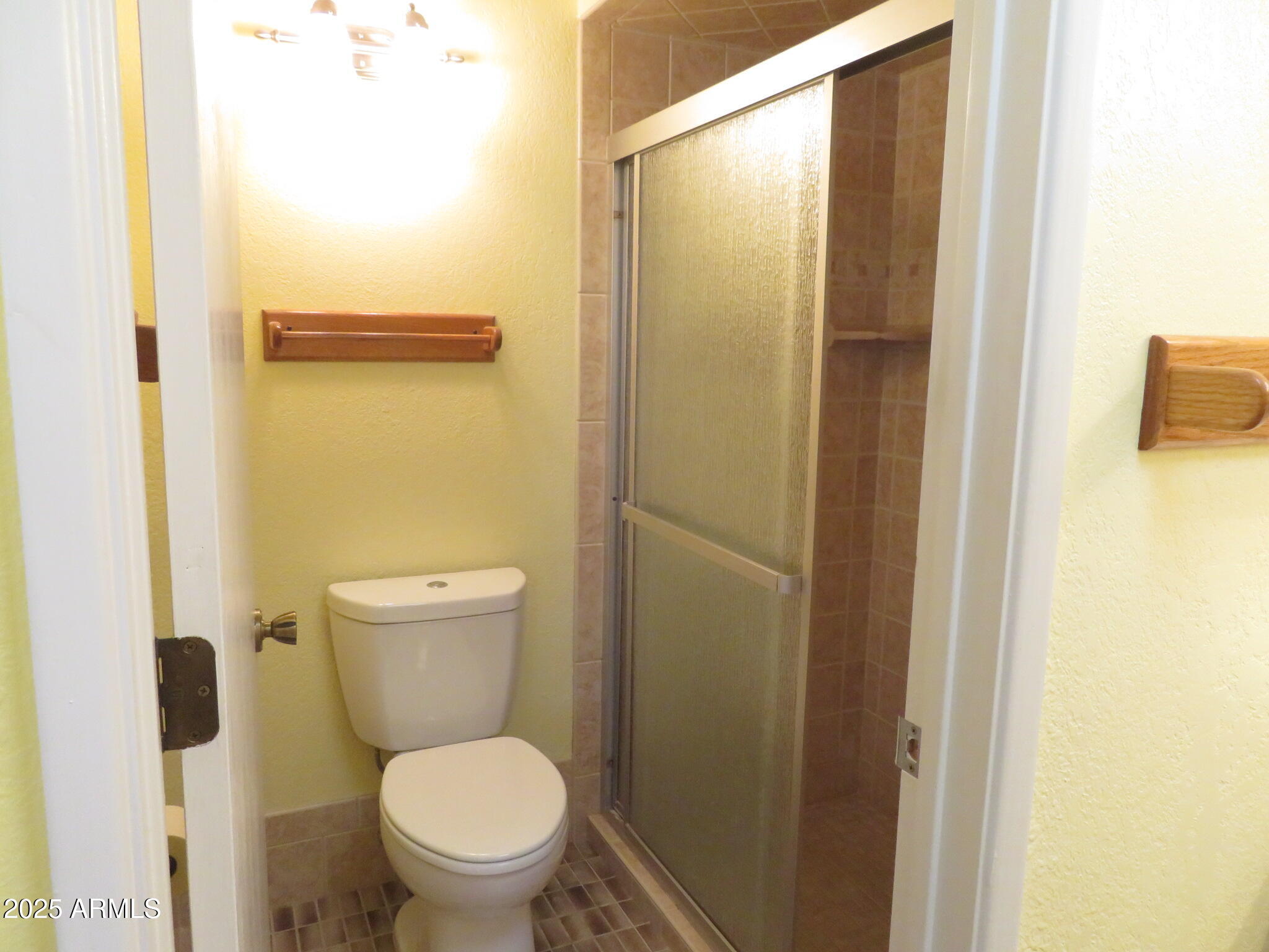 3720 Greenbrier Road Sierra Vista, AZ 85650 - Photo 16 of 30 a white toilet sitting next to a bathroom sink