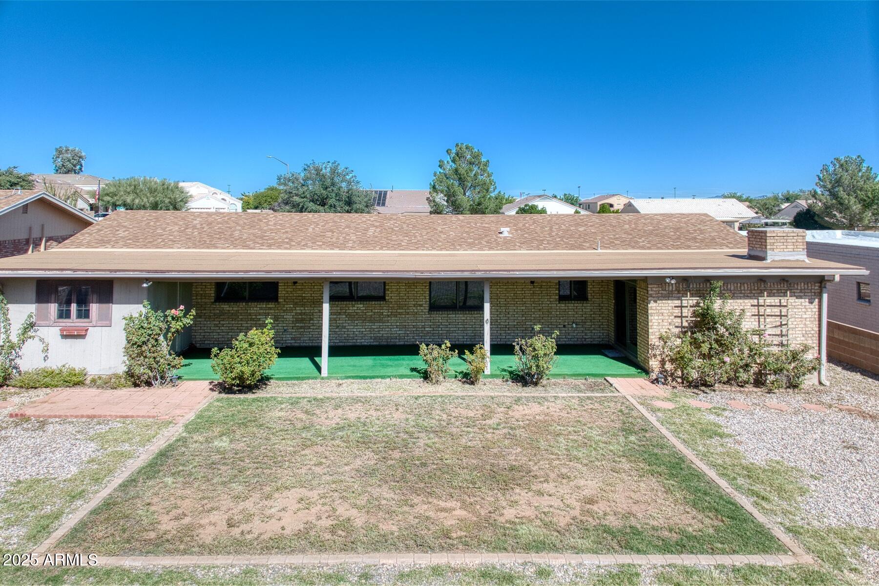 3720 Greenbrier Road Sierra Vista, AZ 85650 - Photo 4 of 30 a front view of a house with a yard and potted plants