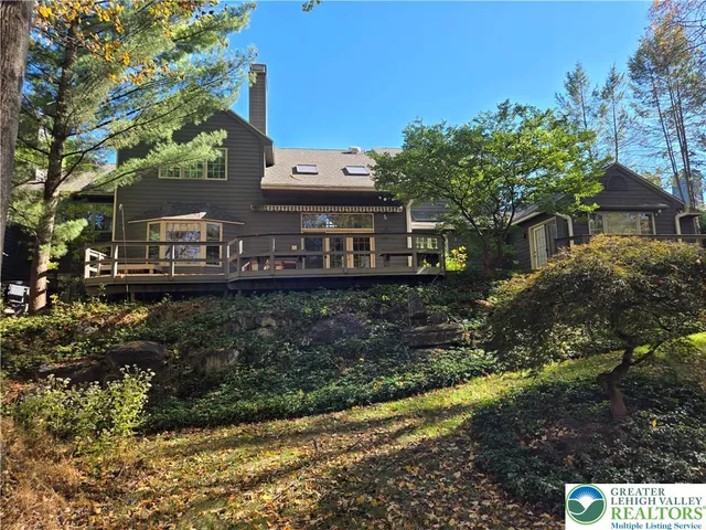 a view of a house with a yard and potted plants
