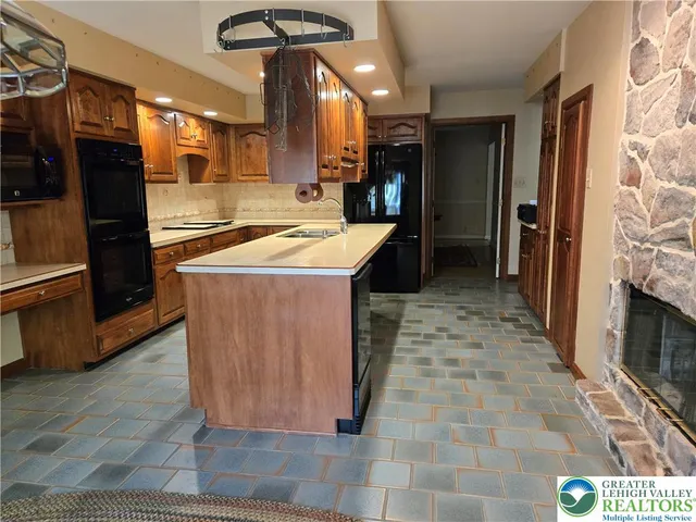 a kitchen with stainless steel appliances granite countertop a sink stove and cabinets
