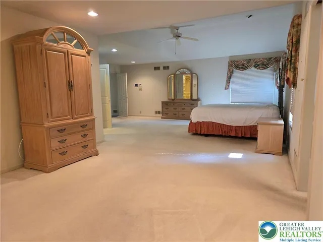 a bedroom with a bed and a night stand