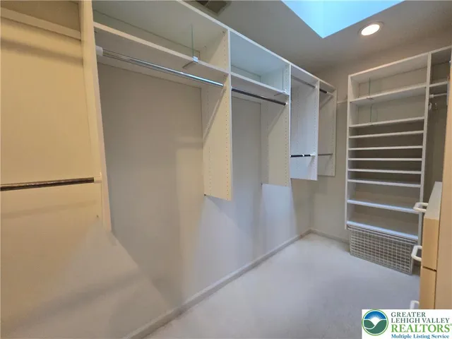 a view of walk in closet with empty racks
