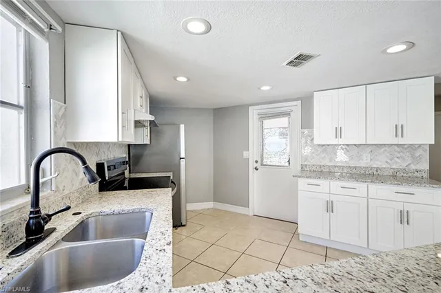 a kitchen with a sink cabinets and window