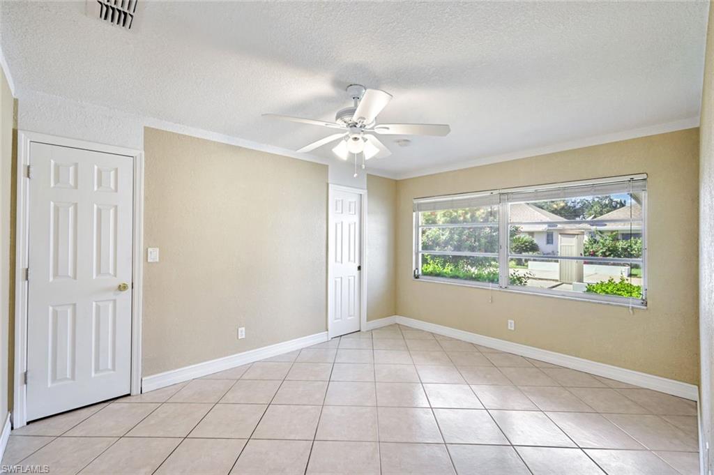 321 Dania Street Lehigh Acres, FL 33936 - Photo 15 of 22 an empty room with windows and ceiling fan