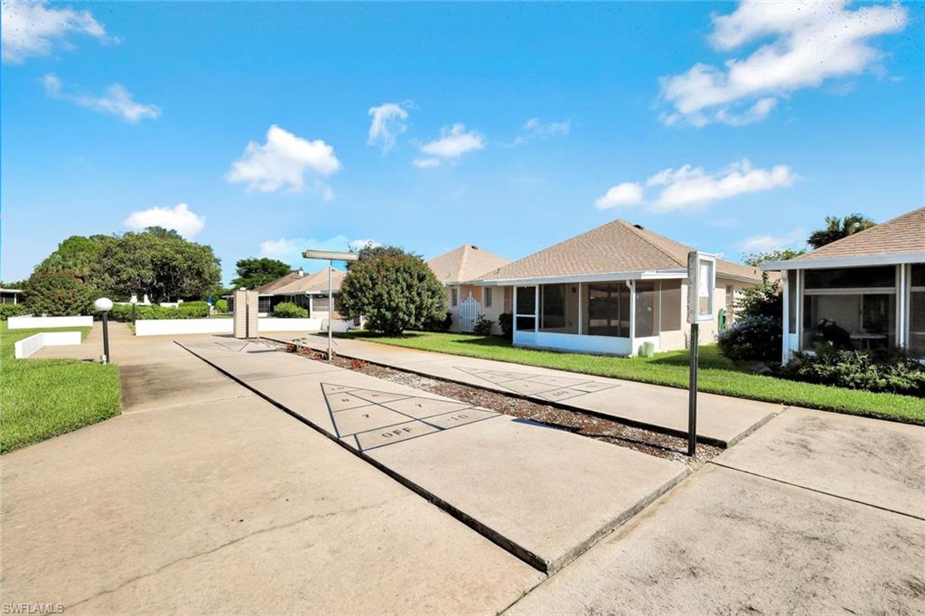 321 Dania Street Lehigh Acres, FL 33936 - Photo 20 of 22 a view of house with outdoor space and street view