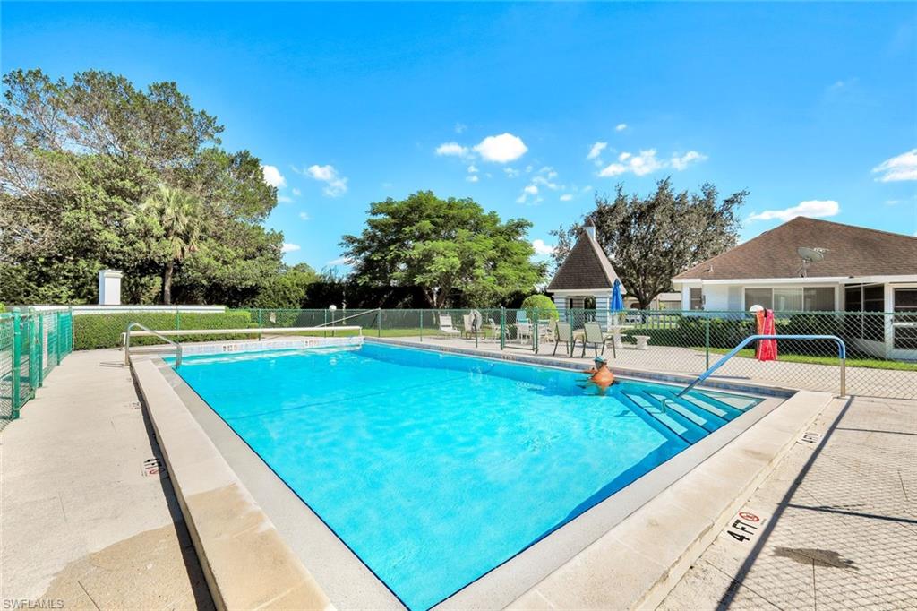 321 Dania Street Lehigh Acres, FL 33936 - Photo 22 of 22 a view of swimming pool with lounge chair
