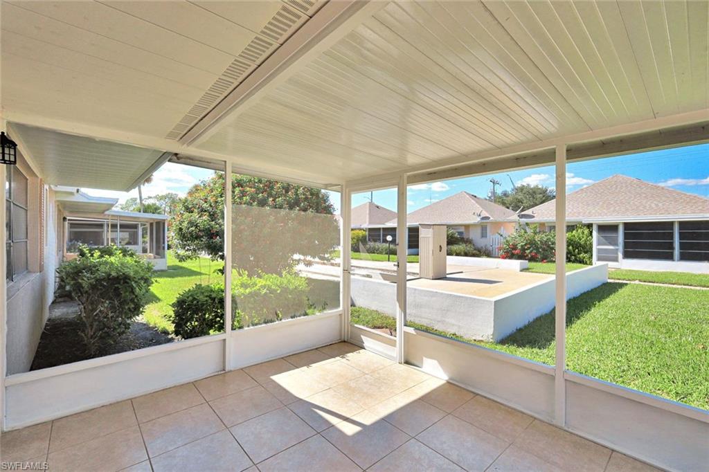 321 Dania Street Lehigh Acres, FL 33936 - Photo 5 of 22 a view of a patio with table and chairs potted plants