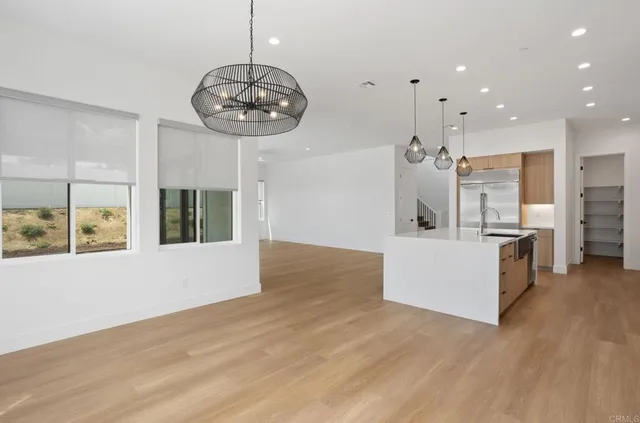 a view of a kitchen with a sink stainless steel appliances and cabinets
