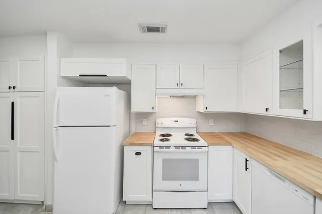 a kitchen with cabinets appliances and a counter space