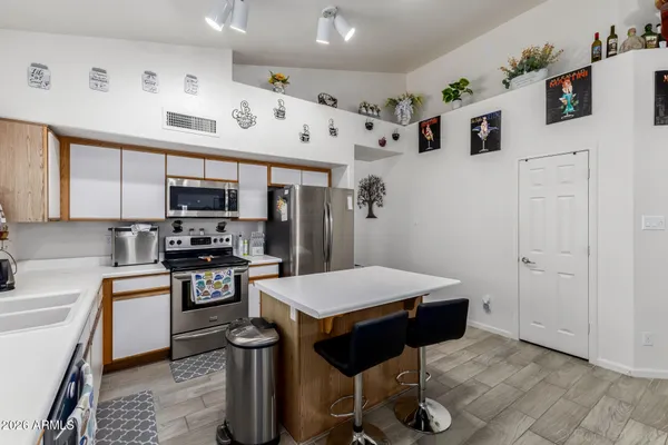 a kitchen with stainless steel appliances a microwave a sink a stove and refrigerator