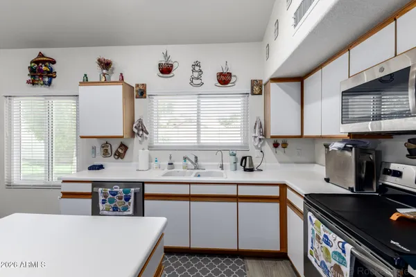 a kitchen that has a sink and a stove in it