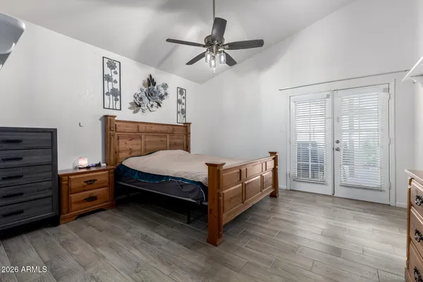 a bedroom with a bed and a chandelier