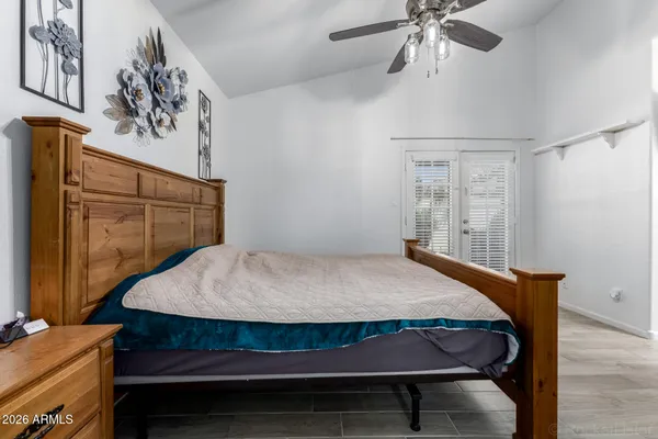 a bedroom with a bed and a chandelier