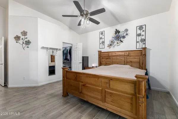 a bedroom with a bed and a ceiling fan