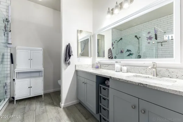 a en suite bathroom with a sink and a mirror