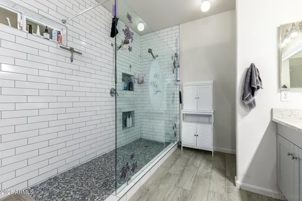 a bathroom with a sink a toilet and shower