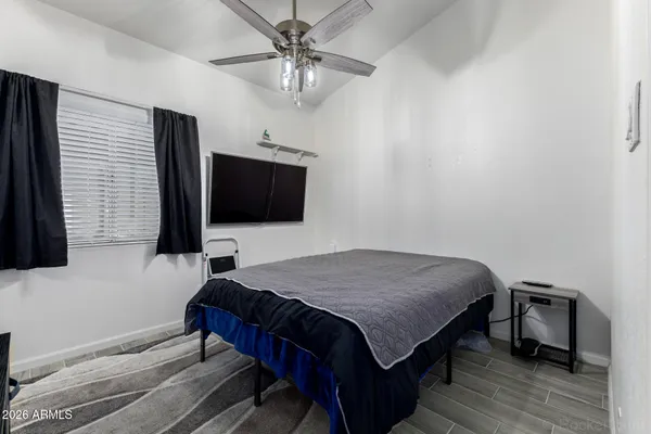 a bedroom with a bed and a flat screen tv
