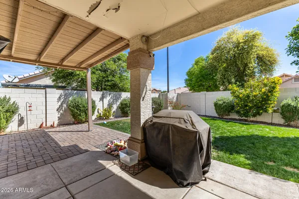 a view of backyard with outdoor seating and green space