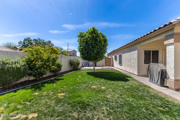 a backyard of a house with lots of green space and lake view