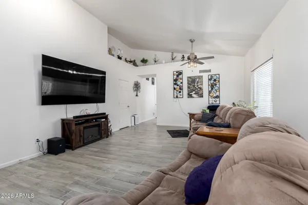 a living room with furniture and a flat screen tv
