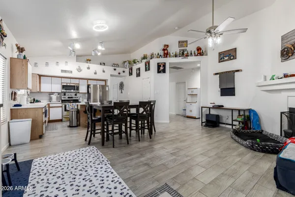 a large kitchen with stainless steel appliances lots of counter space and furniture