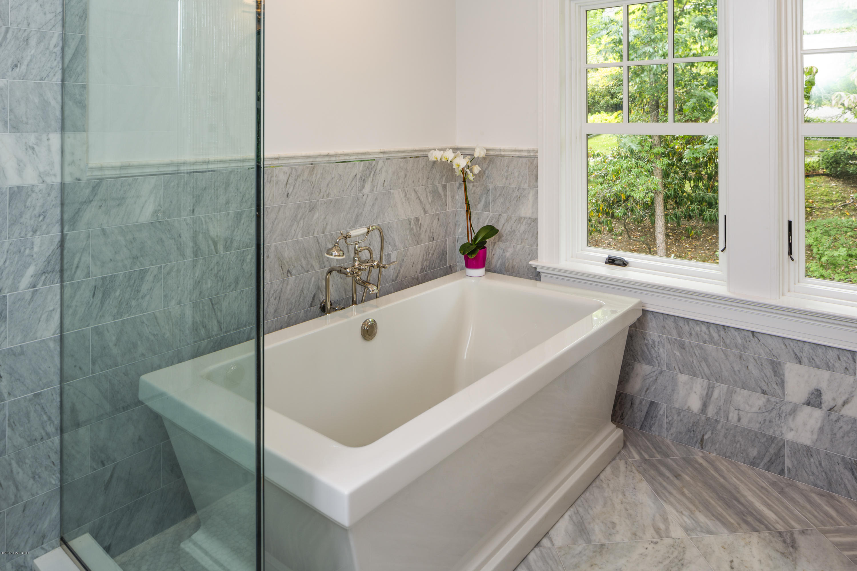 146 Hendrie Avenue Riverside, CT 06878 - Photo 21 of 32 a white bath tub sitting in a bathroom next to a window