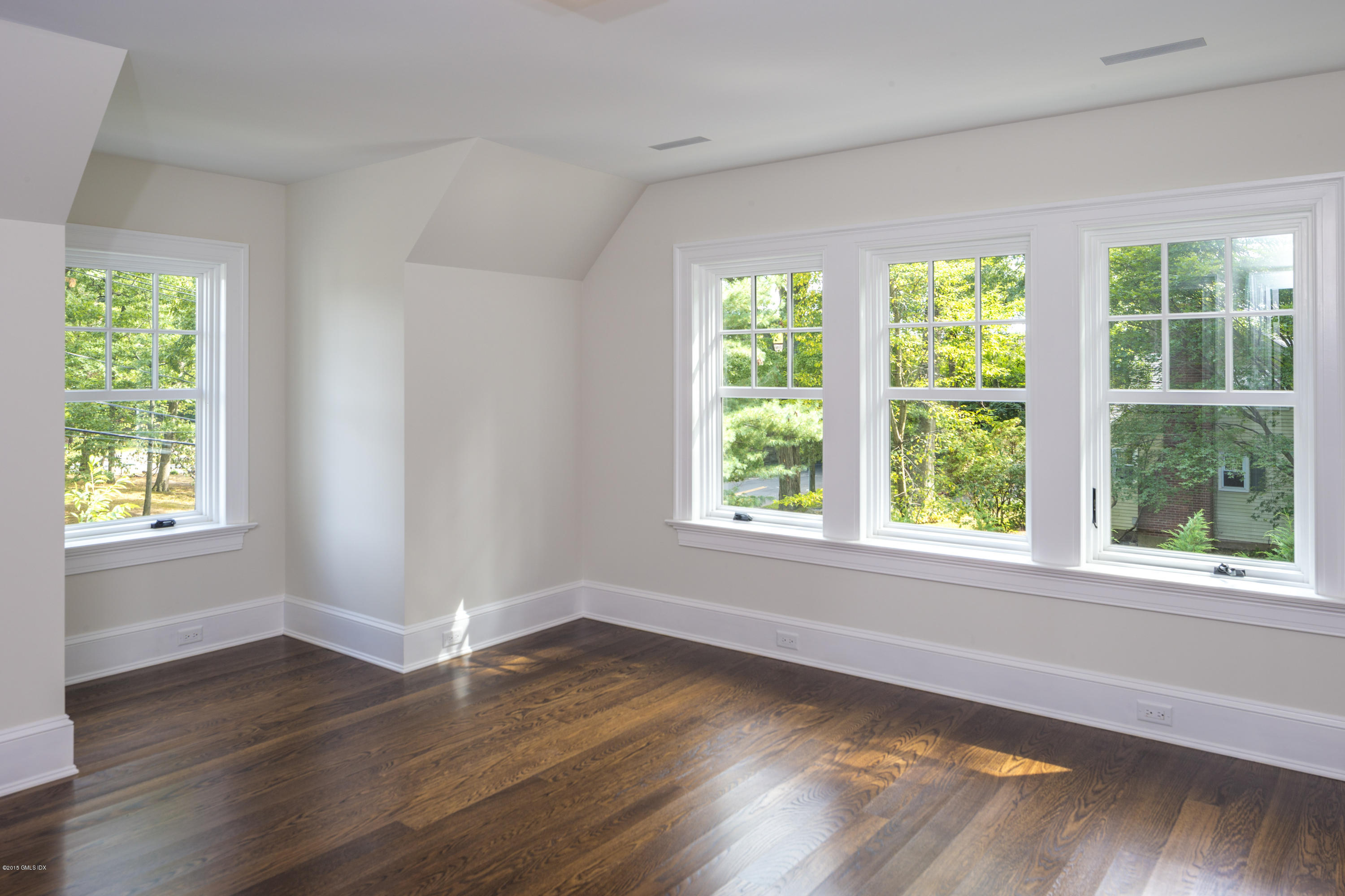 146 Hendrie Avenue Riverside, CT 06878 - Photo 22 of 32 a view of an empty room with wooden floor and a window