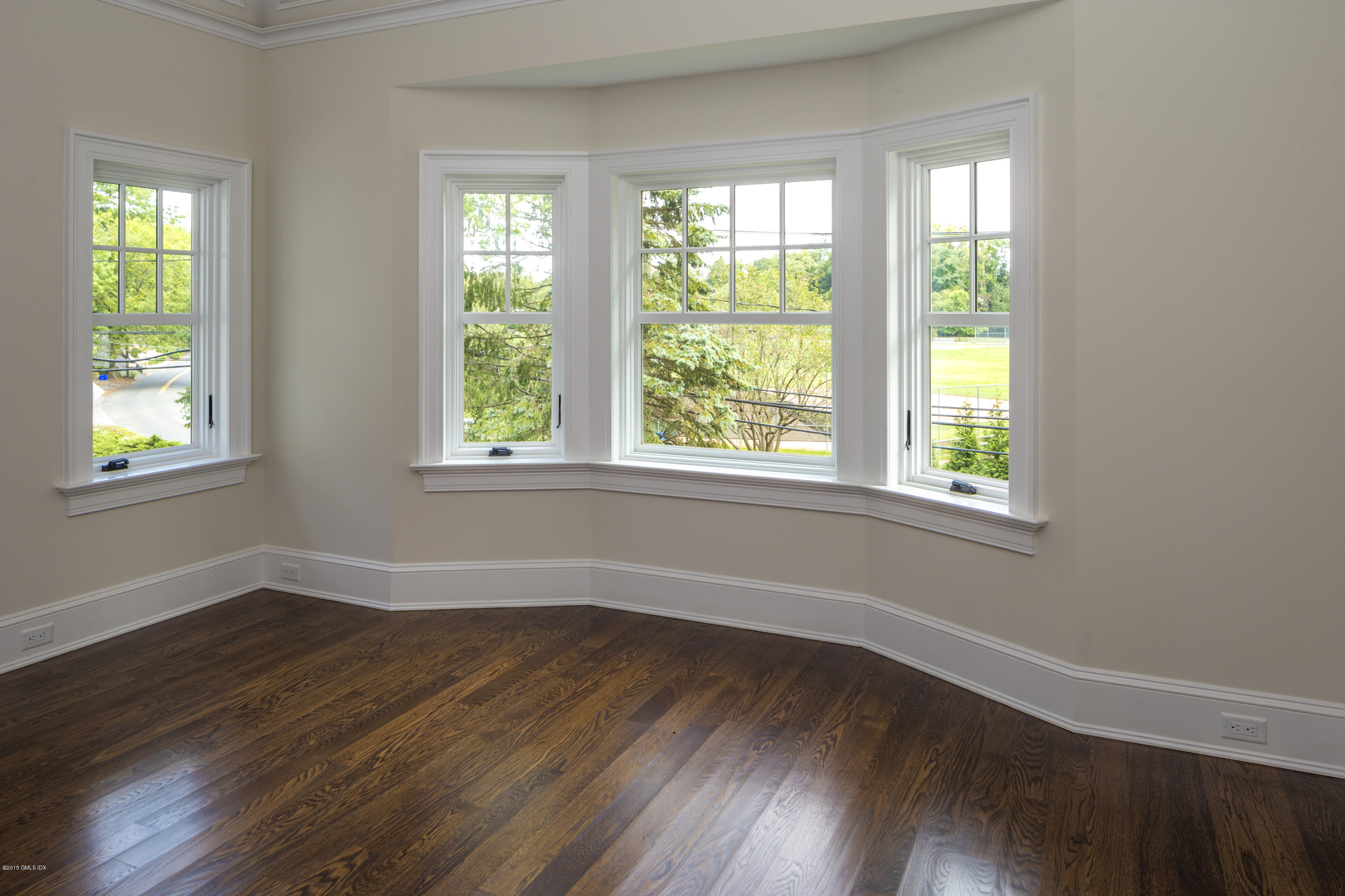 146 Hendrie Avenue Riverside, CT 06878 - Photo 23 of 32 a view of an empty room with wooden floor and a window