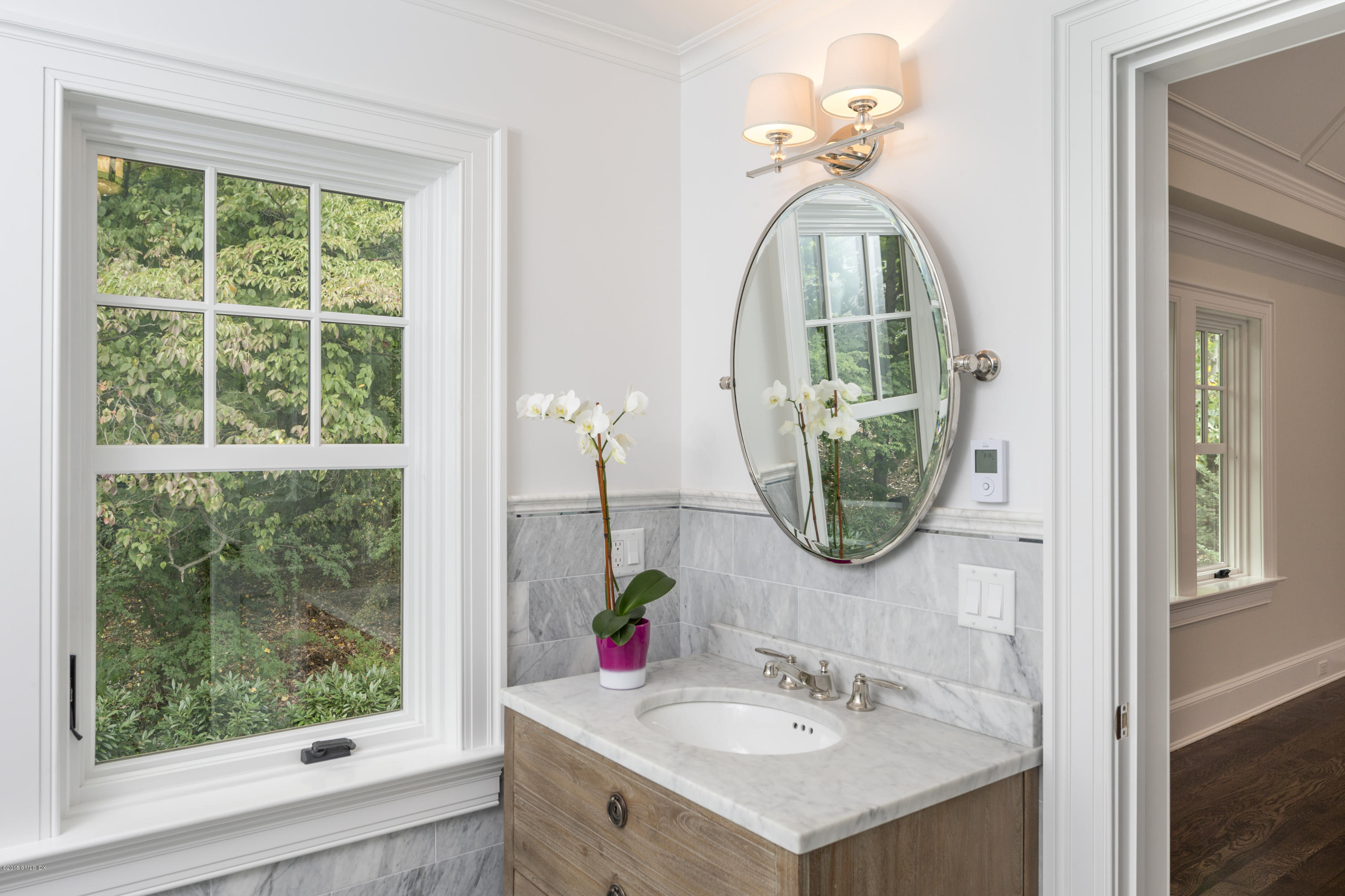 146 Hendrie Avenue Riverside, CT 06878 - Photo 24 of 32 a bathroom with a sink and a mirror