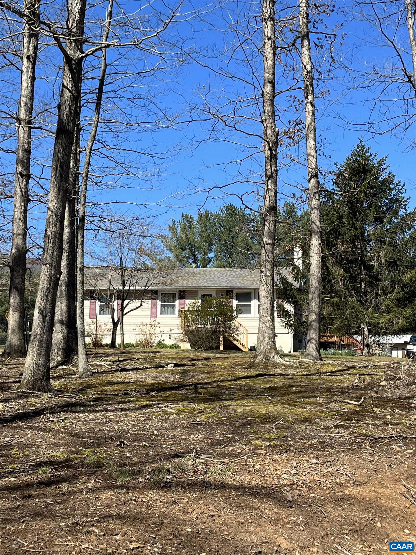 4244 Slam Gate Road Crozet, VA 22932 - Photo 1 of 3 a view of a house with car parked next to a road
