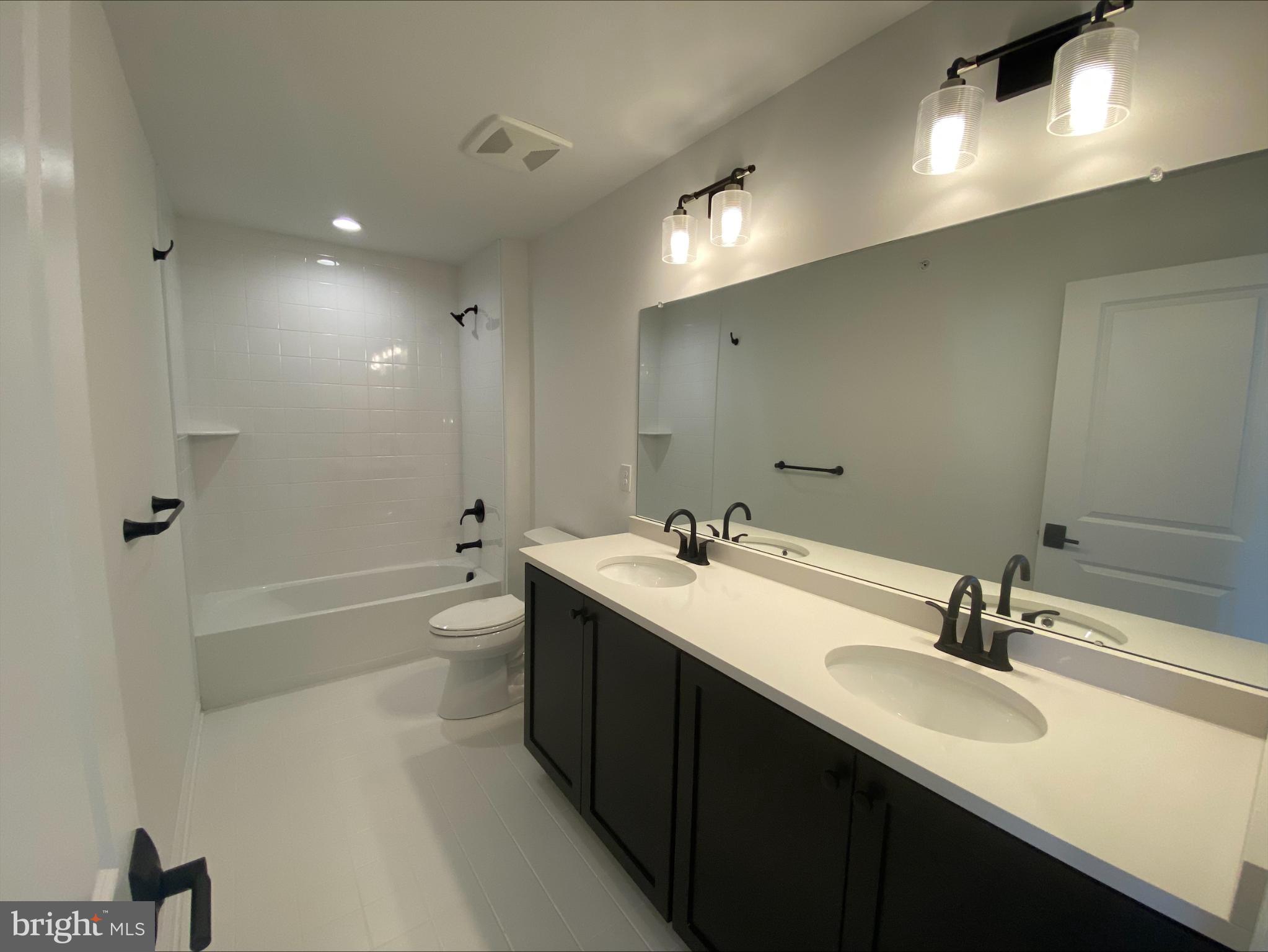 8 Valley Oak Road, Unit 37 Glenmoore, PA 19343 - Photo 13 of 15 a bathroom with a double vanity sink a toilet and shower