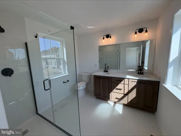 a bathroom with a sink a mirror and a shower