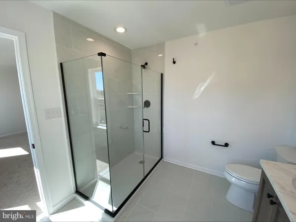 a bathroom with a shower toilet and sink