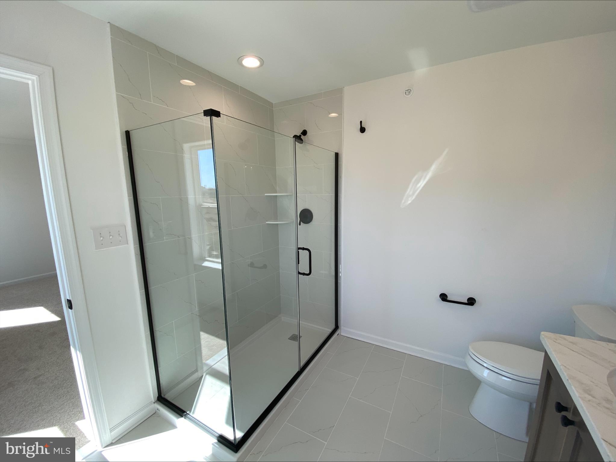 8 Valley Oak Road, Unit 37 Glenmoore, PA 19343 - Photo 8 of 15 a bathroom with a shower toilet and sink