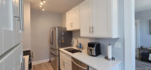 a kitchen with a refrigerator and cabinets
