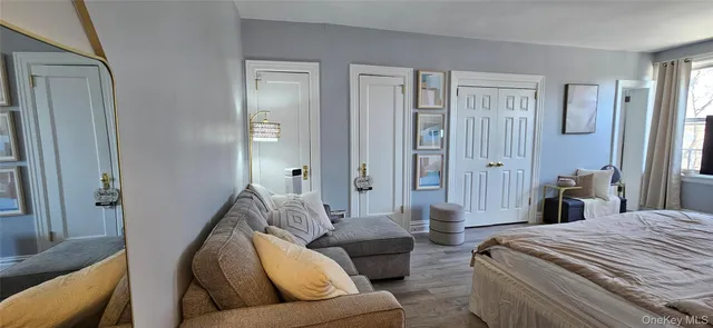 a bedroom with furniture and a wooden floor