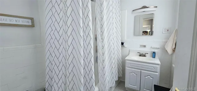 a bathroom with a sink a mirror and a shower