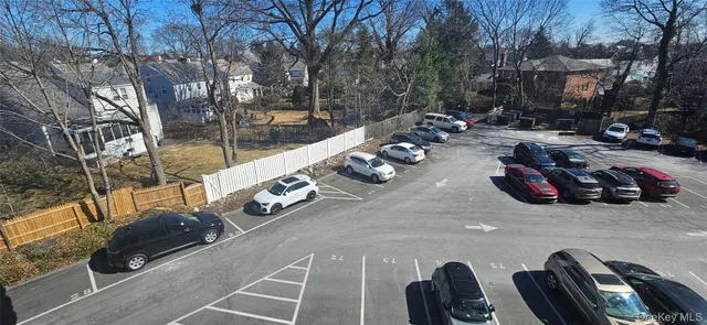 a view of a parking space with cars parked