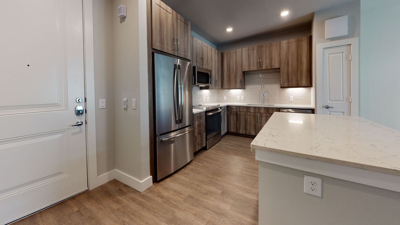 24002 Colonial Parkway, Unit 6130 Katy, TX 77493 - Photo 8 of 31 a kitchen with a refrigerator a sink and cabinets