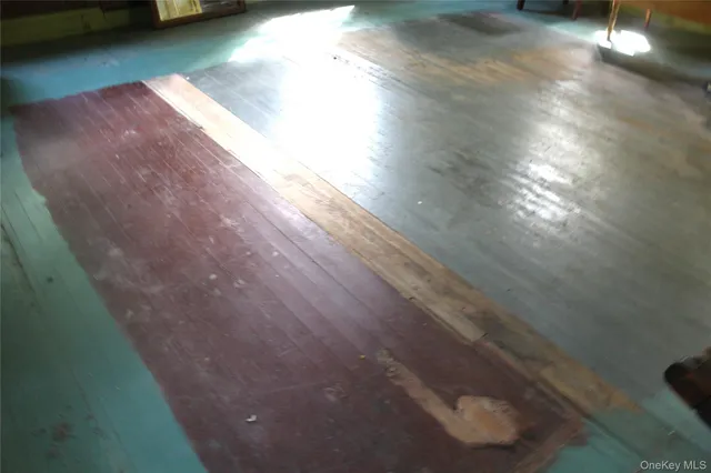 a view of room with wooden floor