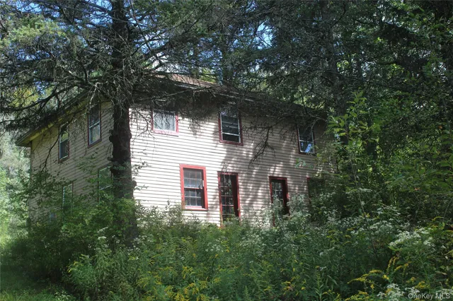 a view of a house with a tree
