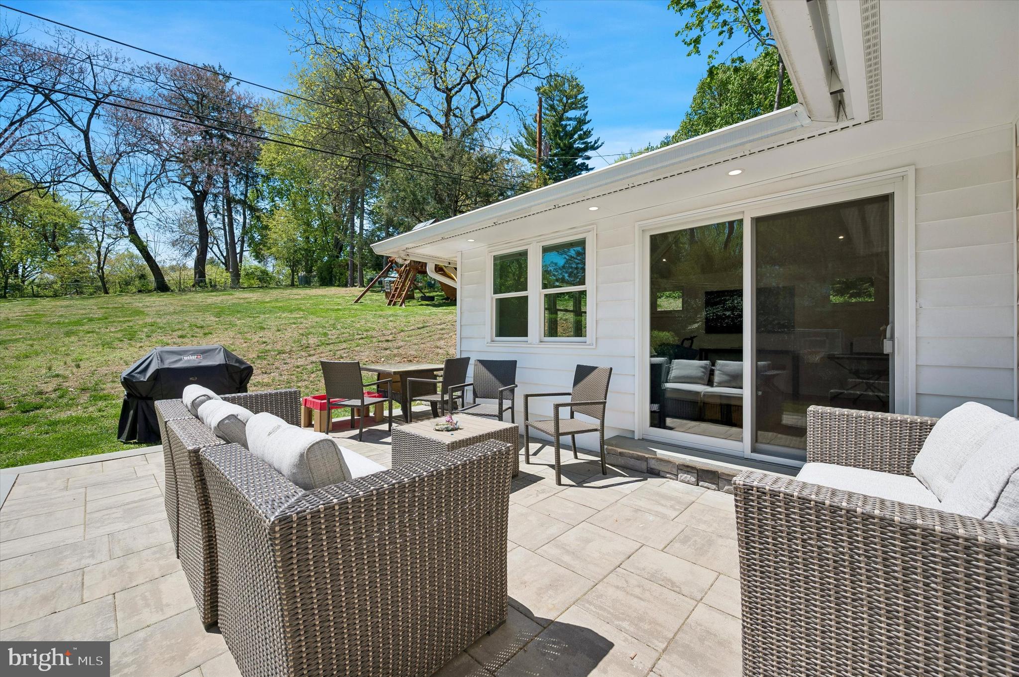 774 Robinhood Road Bryn Mawr, PA 19010 - Photo 13 of 28 a view of a patio with couches potted plants and a big yard