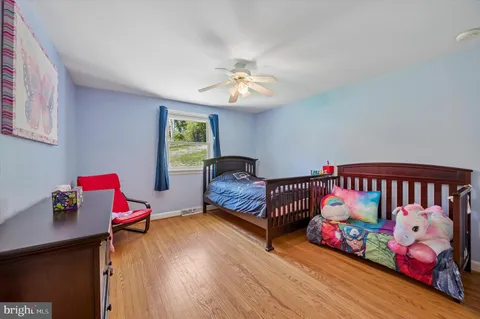 a bedroom with furniture with wooden floor