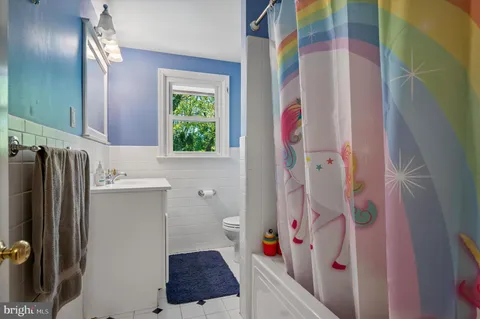 a bathroom with a sink and a shower curtain