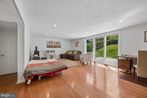 a bedroom with furniture and a large window