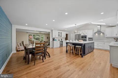 a view of kitchen with kitchen island dining table and stainless steel appliances
